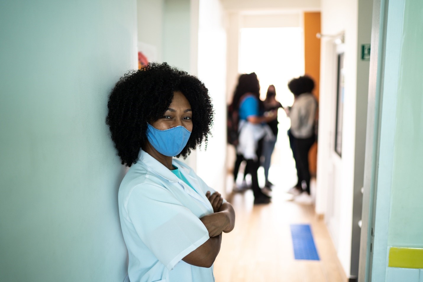 A young woman in medical uniform wearing mask