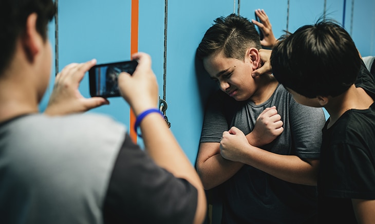 Children are taking a picture of a child against his will