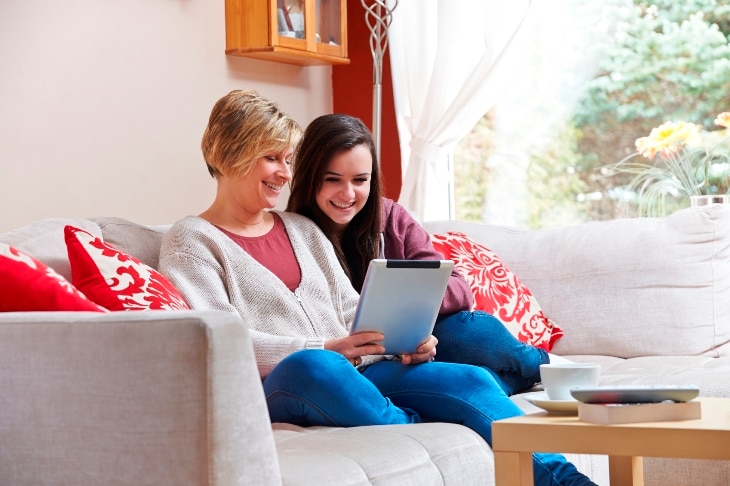 Mother and daughter reading from a tablet