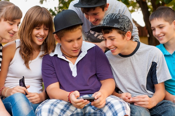 Children looking at a cell phone