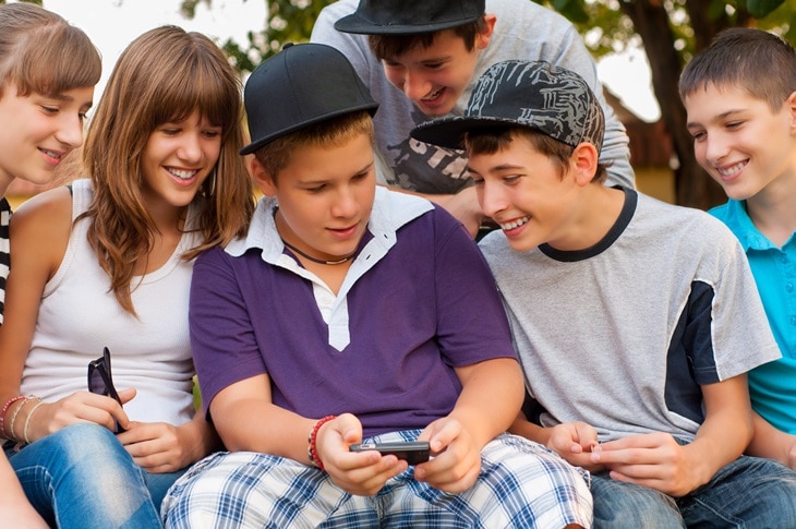 Children looking at a cell phone