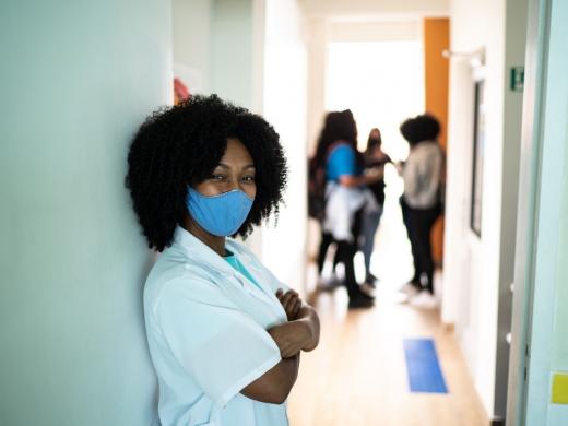 A young woman in medical uniform wearing mask